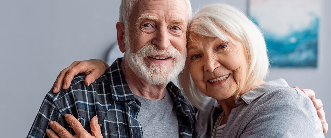 An elderly couple smiling